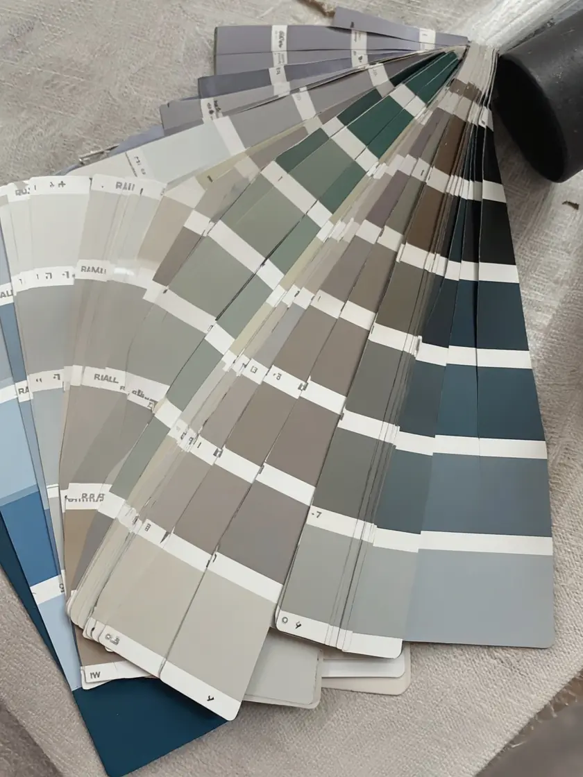 A fanned-out set of RAL paint colour sample swatches